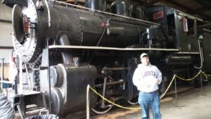 A man standing in front of a locomotive